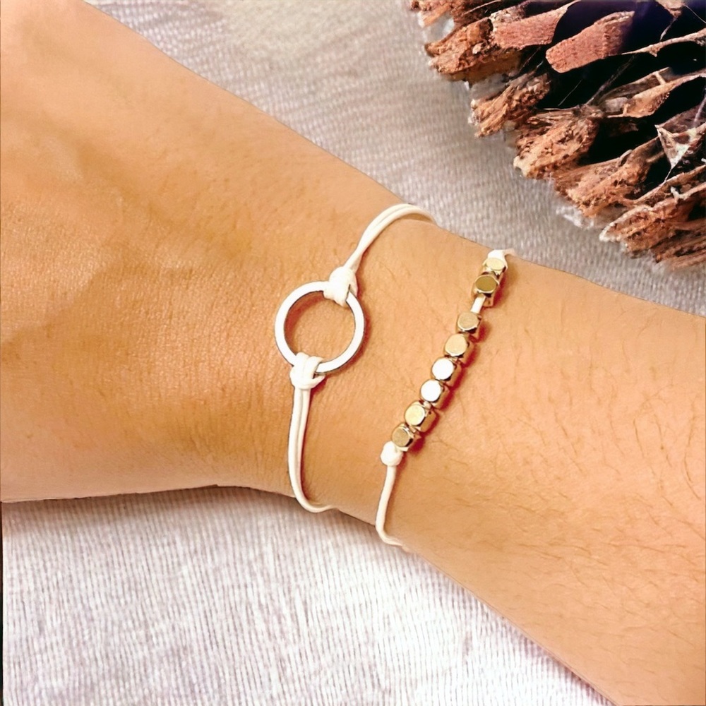 Two Adjustable White Bracelets With Gold Tone Beads